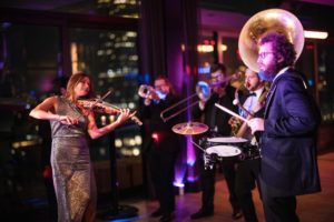 A group of people playing music at a Gotham Hall wedding.