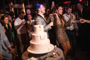 A couple cutting their wedding cake at Gotham Hall.