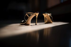 A pair of high heeled shoes on a wooden floor, perfect for a summer wedding in Brooklyn.