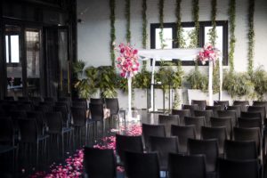 A wedding ceremony set up at 501 Union in Brooklyn, adorned with chairs and pink petals.