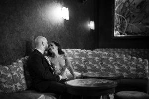Wedding photo of a bride and groom sitting on a couch at 74 Wythe.