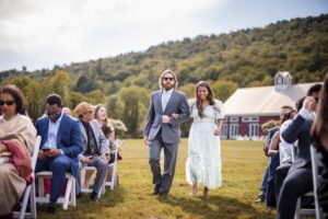 A bride and groom walking down the aisle at a Riverside Farm wedding.