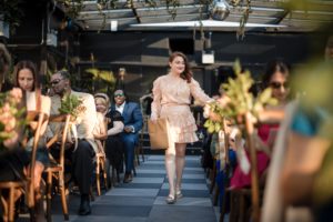 A woman gracefully walking down the aisle at a beautiful wedding venue, 74 Wythe.