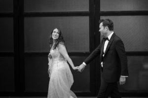 Wedding photo of a bride and groom holding hands at 501 Union in Brooklyn.