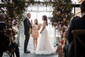 A couple at the 74 Wythe venue exchange vows during their wedding ceremony.
