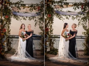 Two brides posing in front of a wedding arch in New York.