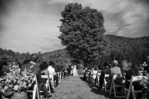 A black and white photo of a wedding ceremony at Riverside Farm.