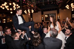 A wedding reception at 501 Union in Brooklyn, with the bride and groom being carried by their guests.