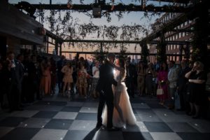 A bride and groom sharing their first dance at a 74 Wythe rooftop wedding.