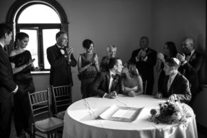A black and white photo of a wedding party at a table in New York.