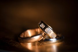 Three wedding rings on a dark background in New York.