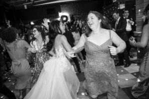 A bride and groom dancing on the dance floor at a wedding reception held at 74 Wythe.