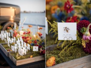 A wedding table in New York adorned with flowers and place cards, elegantly arranged in a wooden box.