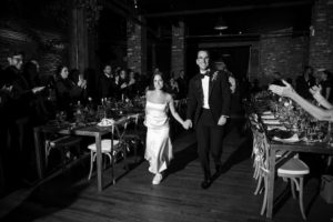 A bride and groom elegantly walking down the aisle at a New York wedding.