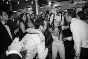 A group of people dancing on the dance floor at a wedding in New York.