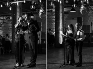 A man and a woman standing in front of a microphone at their New York wedding.