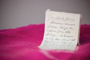 A note is sitting on top of a pink sweater, bringing a touch of wedding elegance in New York.