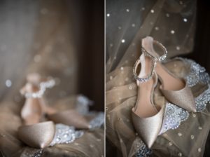 A pair of gold wedding shoes on a bed of tulle in New York.