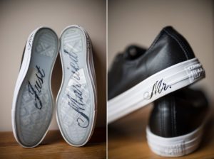 A pair of black converse shoes with New York" written on them.