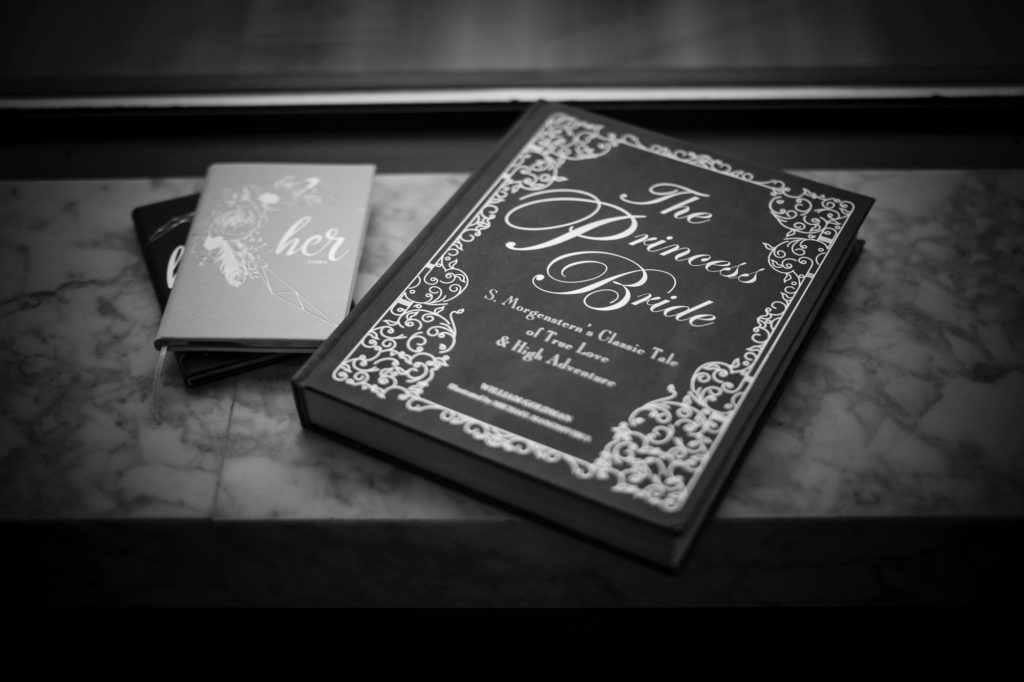 A black and white photo of a book on a table at a wedding in New York.