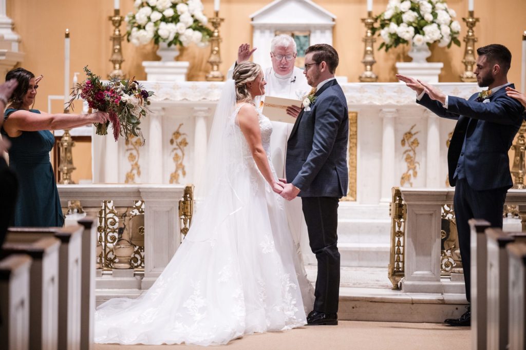 A bride and groom exchange their vows in a church in New York.