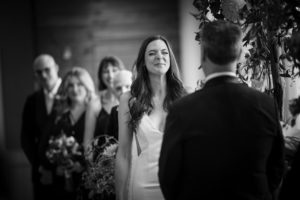 A bride and groom share a tender glance during their wedding ceremony in New York.