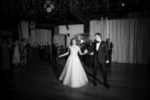 A bride and groom elegantly dance in a black and white photo at their wedding in New York.