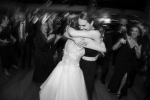 A bride and groom hugging on the wedding dance floor in New York.