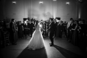 Black and white photo of bride and groom dancing in a New York ballroom at their wedding.