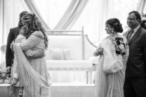 A bride and groom hugging during their wedding ceremony in New York.