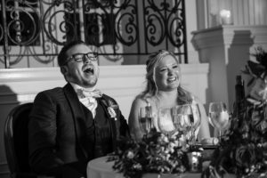 A bride and groom laughing at a wedding reception in New York.