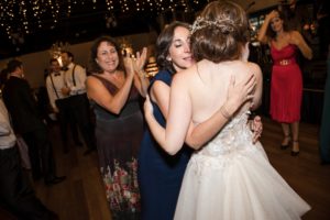 A bride hugging her mother on the dance floor at a New York wedding.