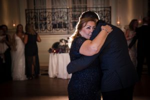A bride and groom hugging during their first dance at their New York wedding.