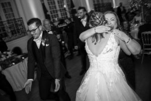 A **wedding** bride and groom hugging on the dance floor in **New York**.