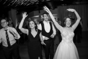 A group of people dancing at a wedding reception in New York.