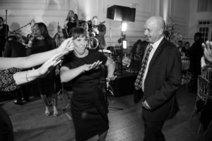 A group of people dancing at a wedding party in New York.