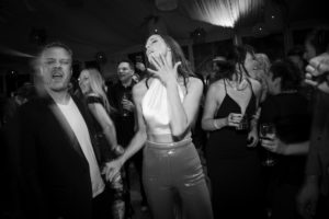 A black and white photo of a man and woman at a wedding party in New York.