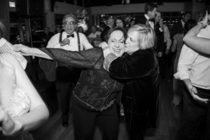 Two women hugging on the dance floor at a New York wedding.