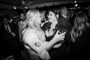 Black and white photo of two women at a wedding party in New York.