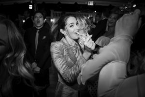 Black and white photo of a woman dancing at a wedding party in New York.