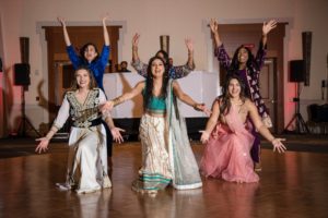 A group of Indian women dancing at a wedding in New York.