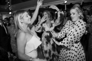 Two women dancing at a party in black and white photo taken at a wedding in New York.