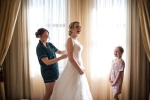 A bride getting ready for her wedding in a hotel room in New York.