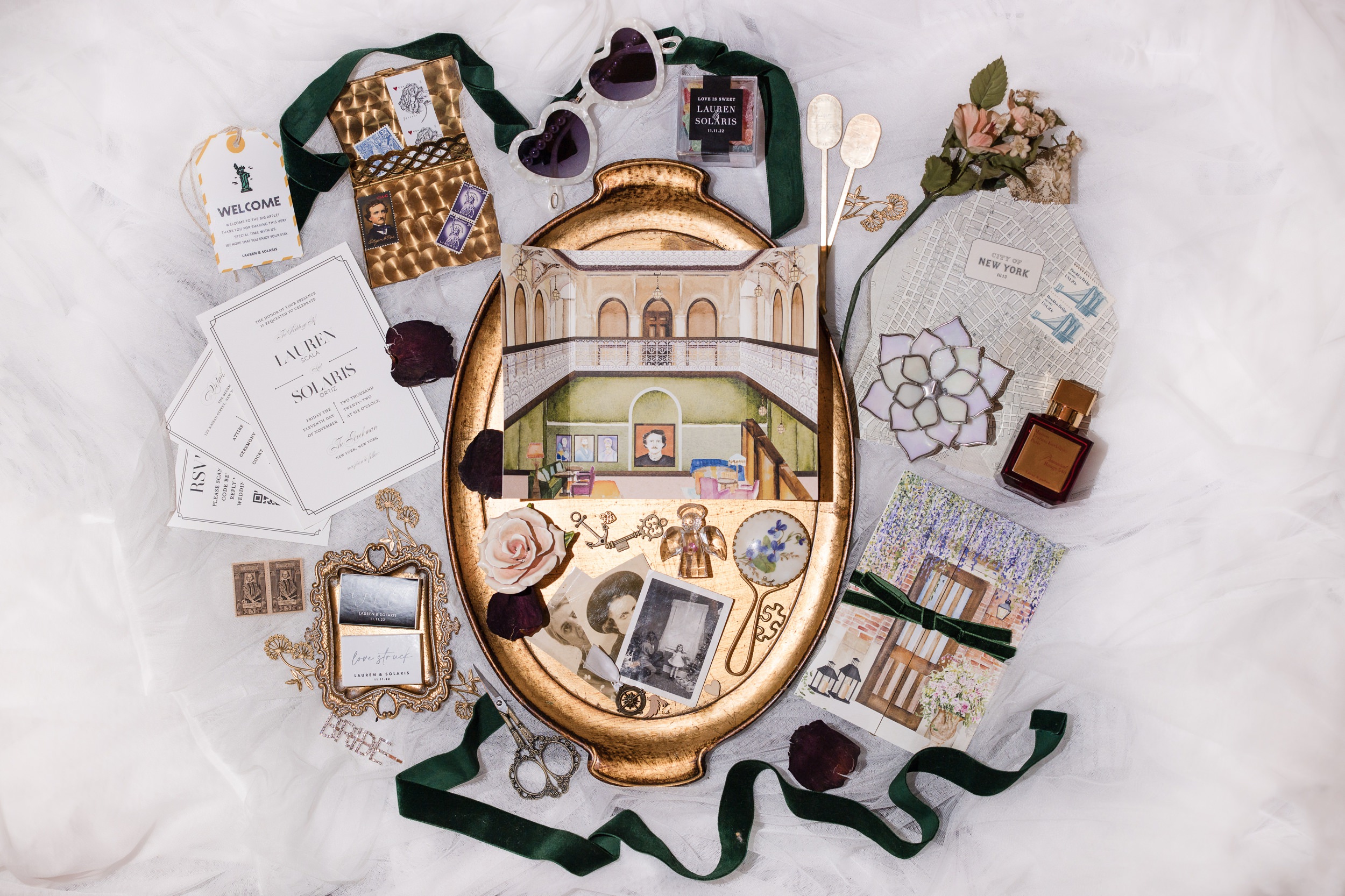 Flat lay image of a wedding invitation, ribbon, and other wedding details at the Beekman Hotel in NYC