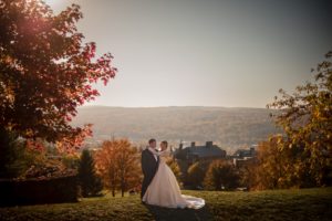 Newlyweds posing for a fall wedding photo in New York.