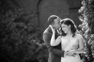 A black and white photo capturing the embrace of a bride and groom during their wedding in New York.