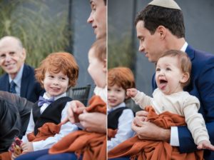 In the bustling streets of New York City, a dapper man in a suit gracefully maneuvers his way through the crowd, pushing a baby in a sleek stroller.