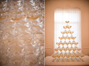 A stack of wine glasses on a table in front of a window in New York City.