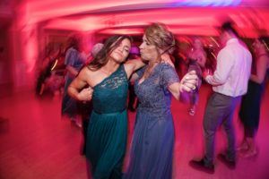 Two women dancing on the dance floor at a wedding in New York.