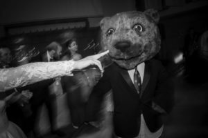A man dressed as a bear is dancing at a wedding in New York.